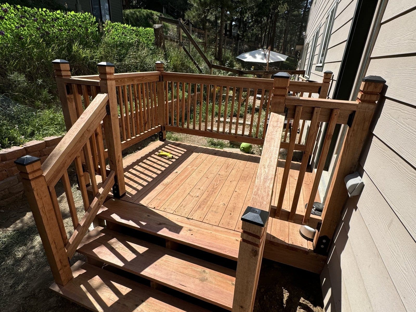 Custom stained wood deck with stairs and railing